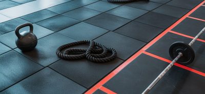 Modern CrossFit gym in Qatar featuring durable rubber flooring, functional training equipment, weightlifting area, and professional fitness setup.