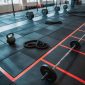 Modern CrossFit gym in Qatar featuring durable rubber flooring, functional training equipment, weightlifting area, and professional fitness setup.