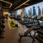 Modern commercial gym in Qatar featuring cardio machines, free weights, strength equipment, and panoramic views of Doha's skyline through large glass windows