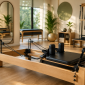 Modern Pilates reformer machine in a bright professional fitness studio with a clean and minimalist interior.